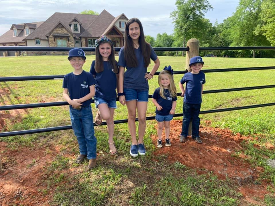 Parker Fence Co. family team beside completed fence installation