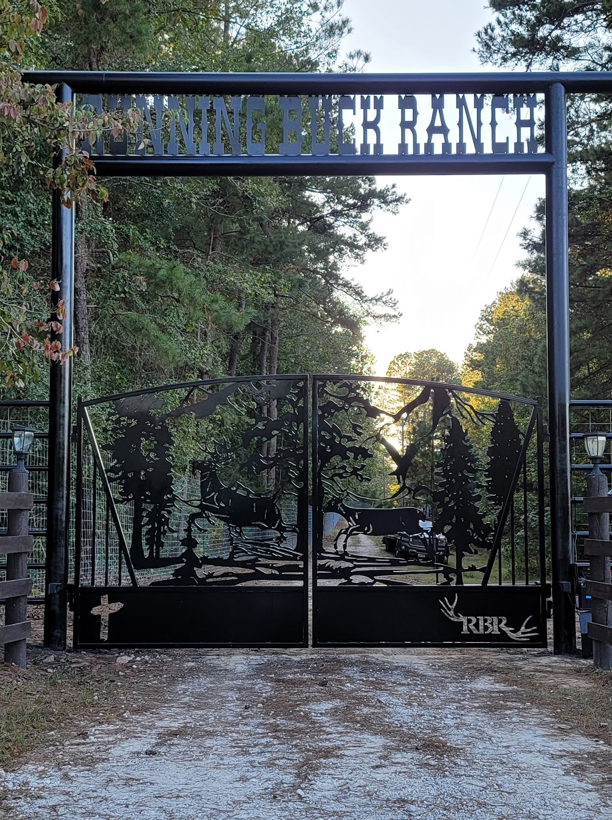 Custom ornamental iron entry gate fabricated and installed by Parker Fence Co.